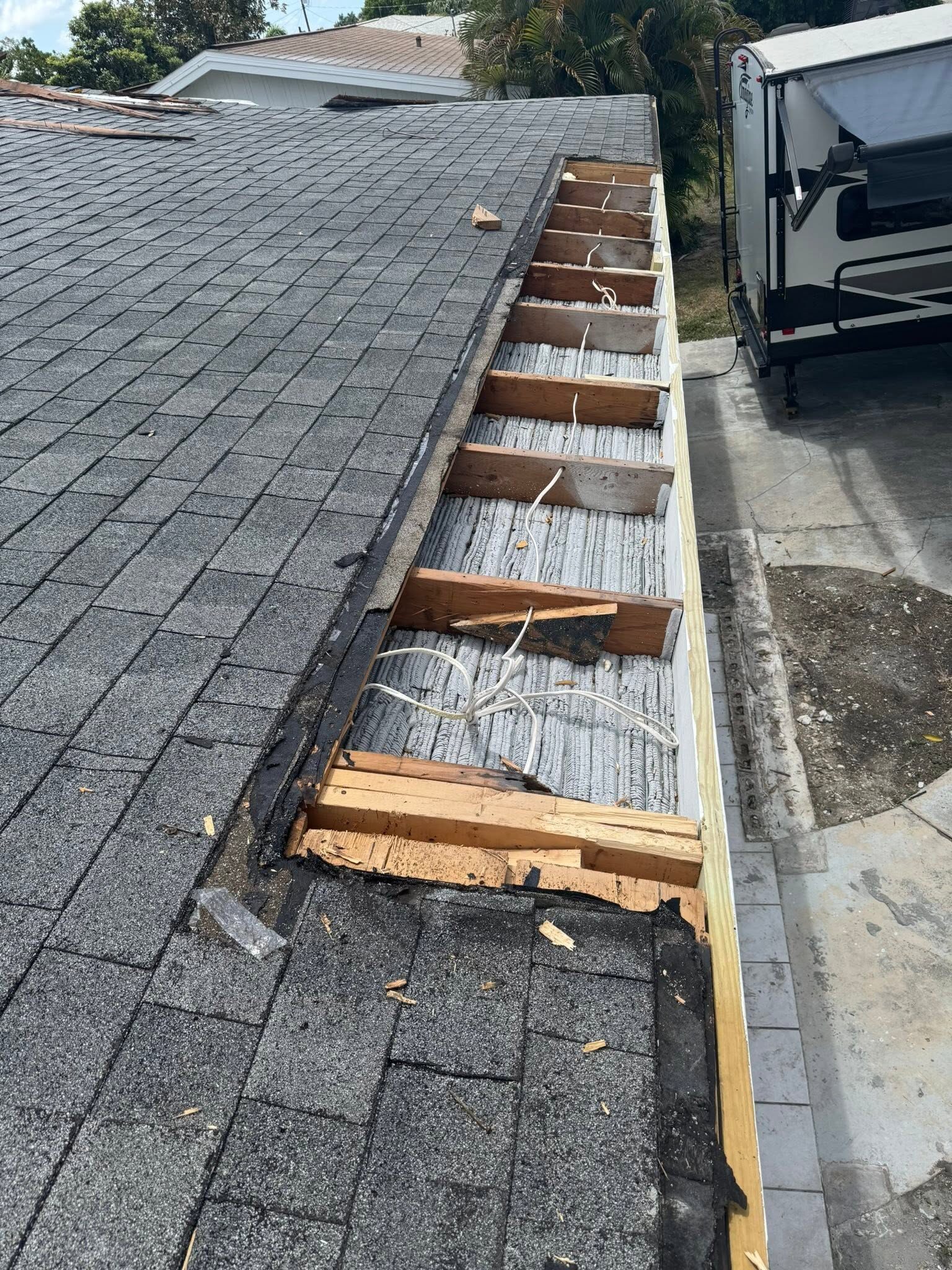 Before: rotted fascia and roof decking exposed at the eave