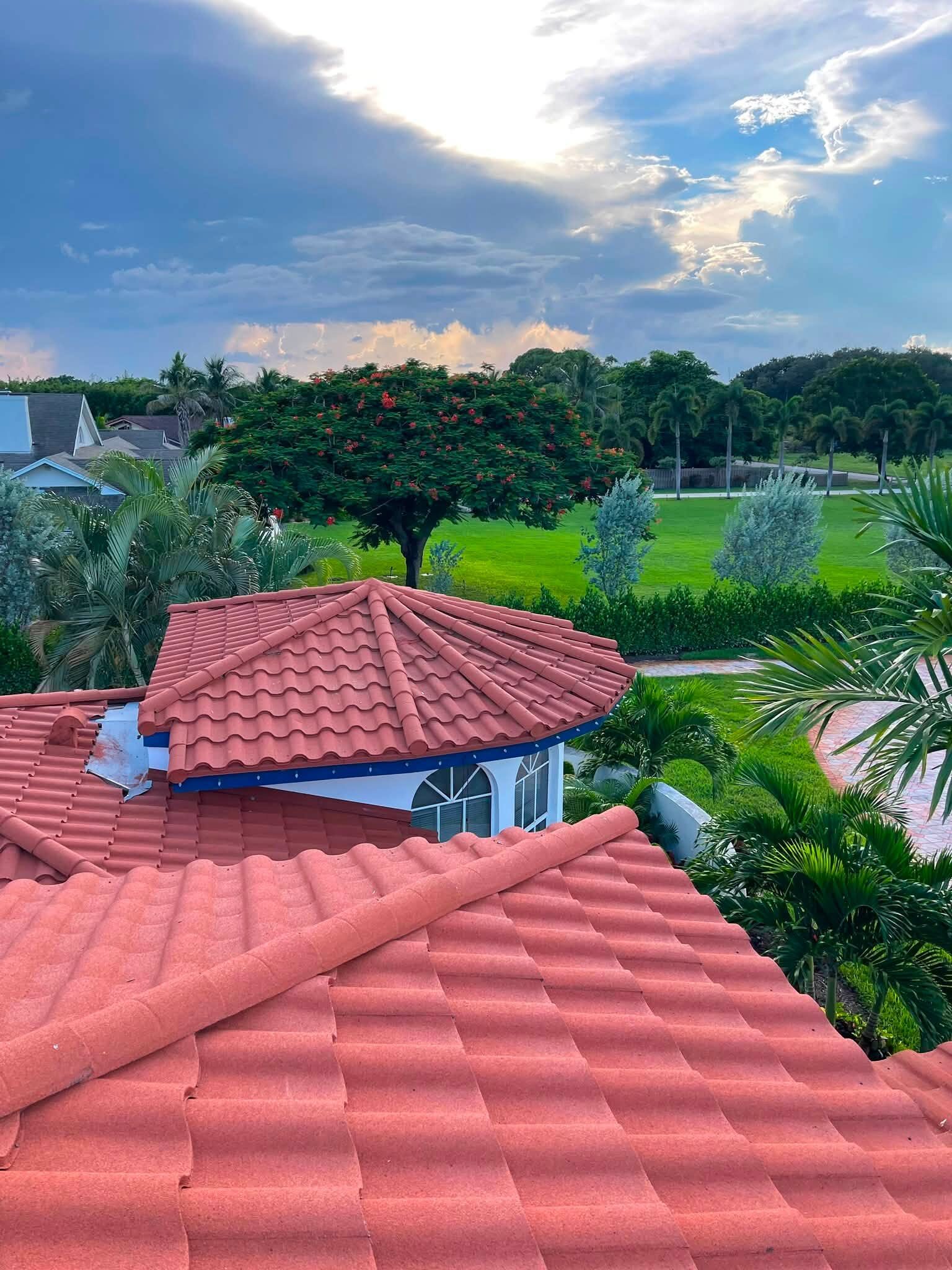 Tile roof gazebo turret with blue trim under a Florida sky