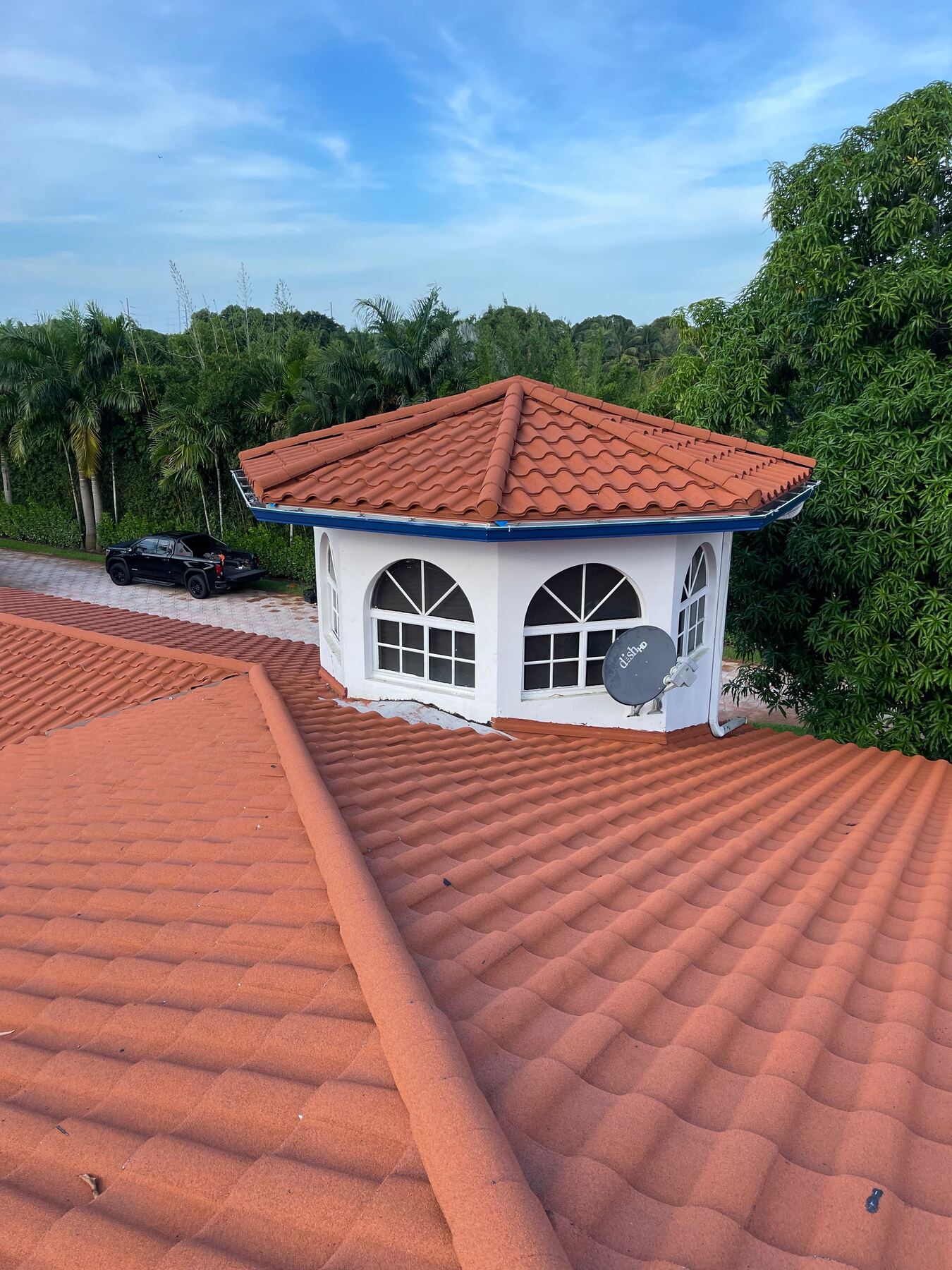 Tile roof gazebo turret with a pickup truck parked in the driveway for scale