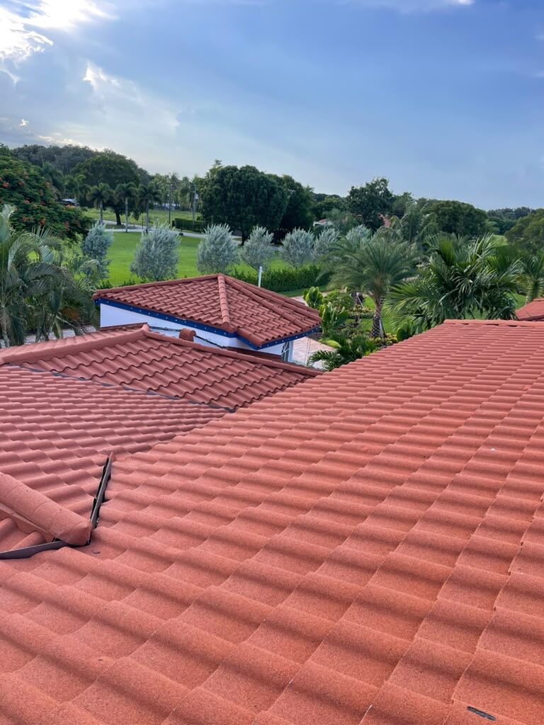 Barrel tile roof with a gazebo turret overlooking a landscaped yard at dusk