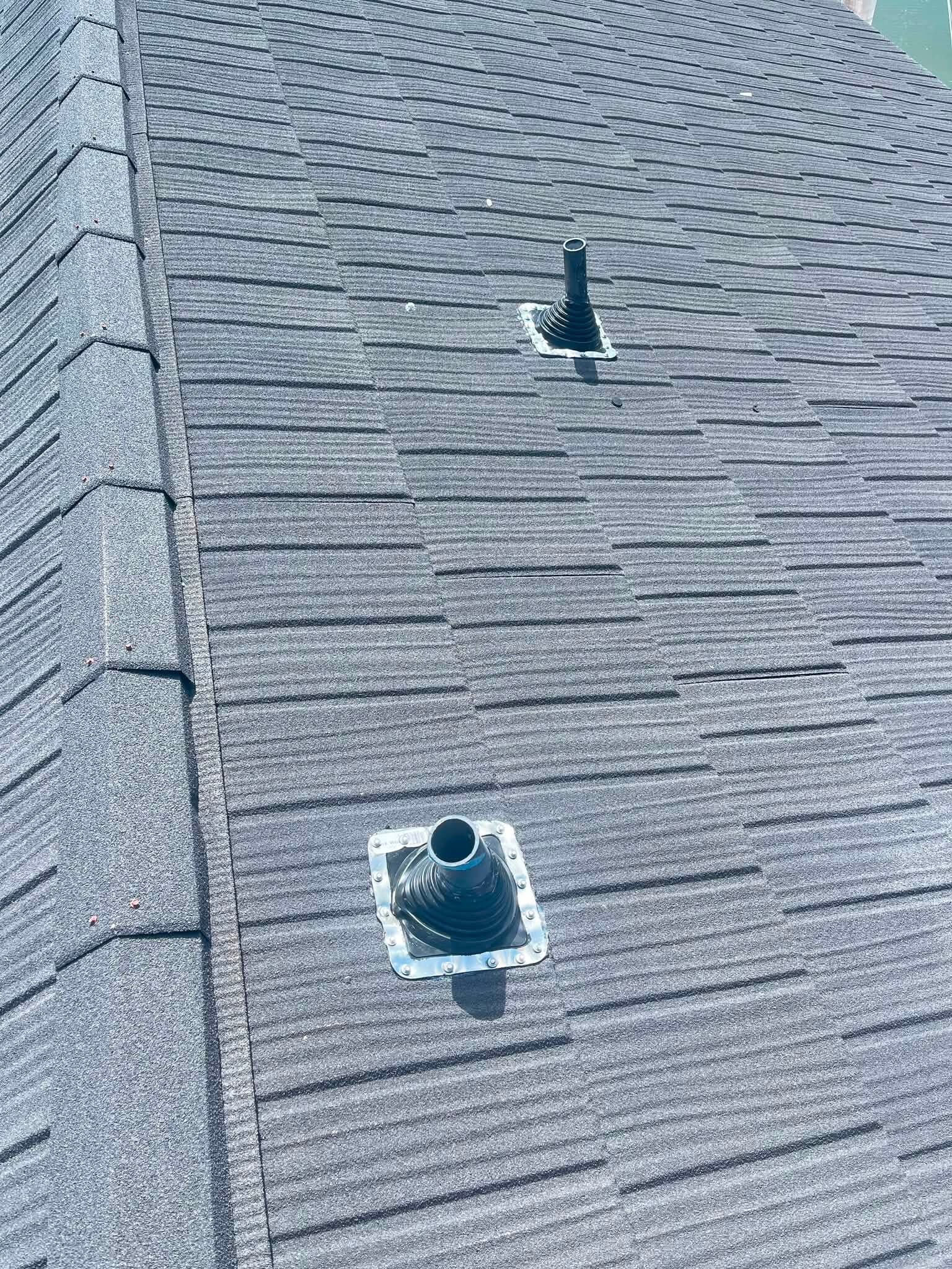 Close-up of roof pipe boot and vent flashing detail